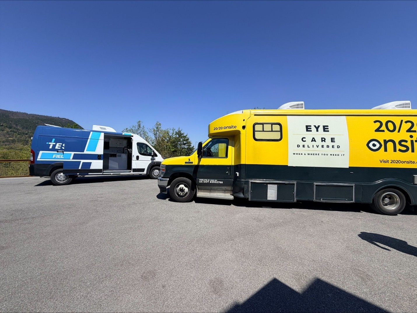 TESCO Specialty Vehicles Field Operations service van parked beside a 20/20 Onsite mobile vision clinic in the field