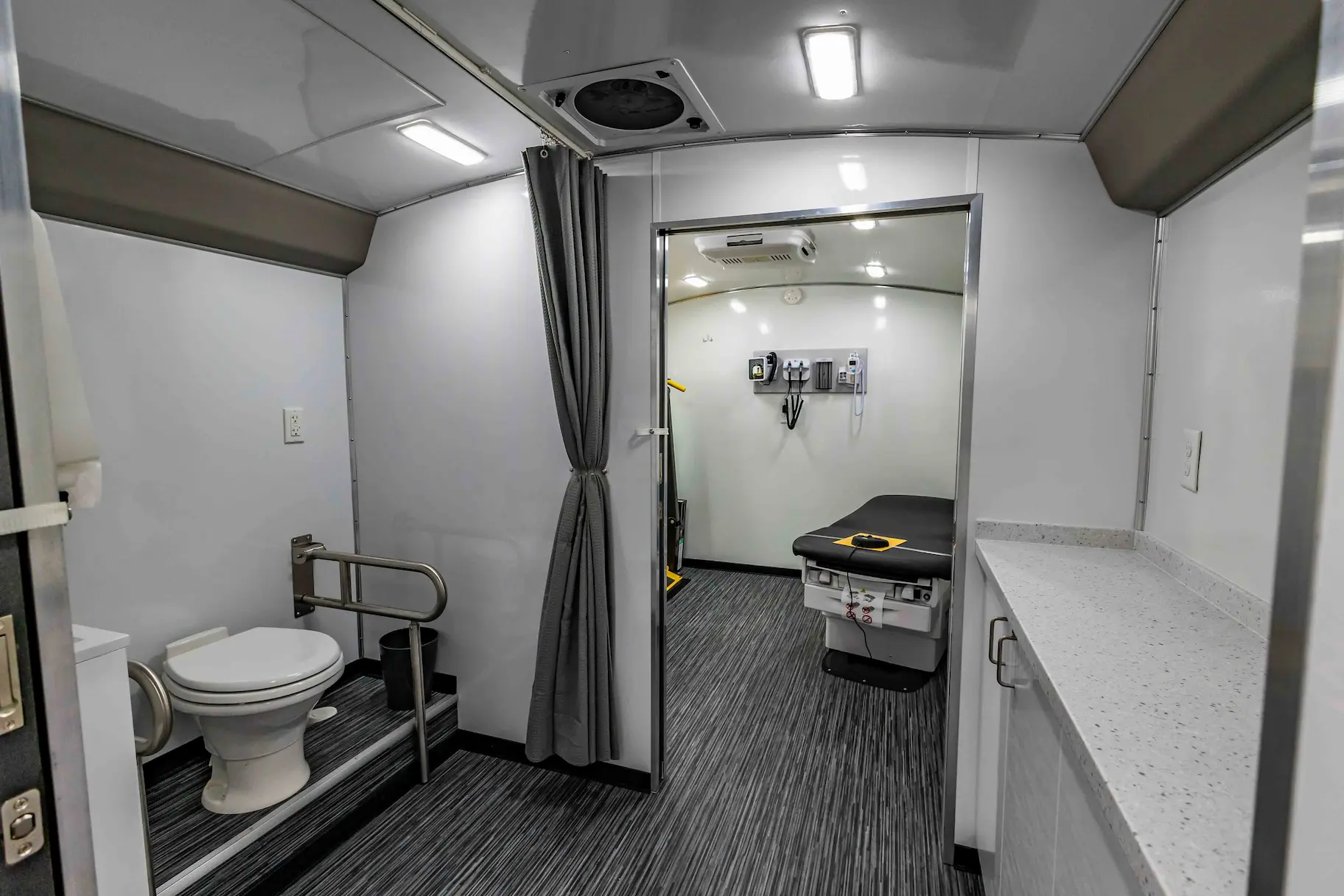 Interior with exam bed of a used 2023 Two Exam Room Mobile Clinic w/ ADA Restroom and Office for sale